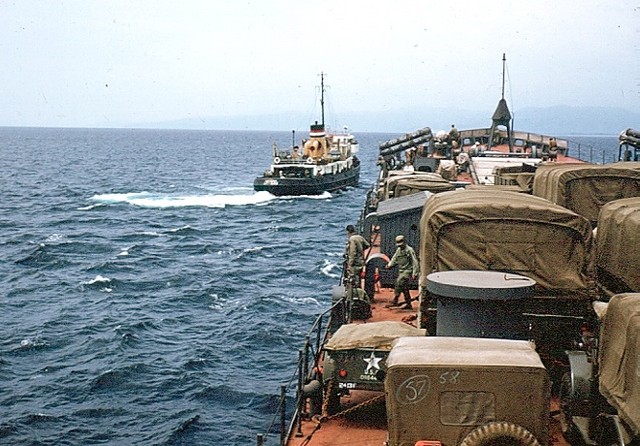 Loaded - tug pulls LST off the beach (1953)