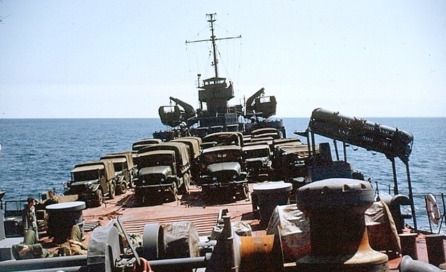 On our way (1953) All new M2ll GM trucks, WWII jeeps, M38A1'S, M37-3/4 TON AND SOME OLD 3/4 DODGE WWII's and M100 trailers. 105 howitzers are  below deck-plus all other stuff.