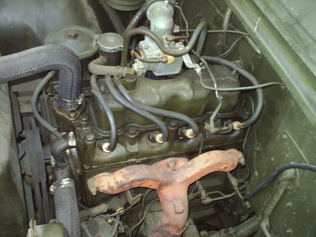 Motor, Driver Side. Showing new spark plugs & wires, new radiator hoses, and the over-hauled carb.
