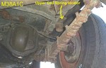 Rear coil spring upper locator 