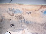 closeup of the undercoating on the body. It is starting to chip in some places, but paint underneath is still in good condition and mostly not rusted. This picture is of the driver's side front fender.